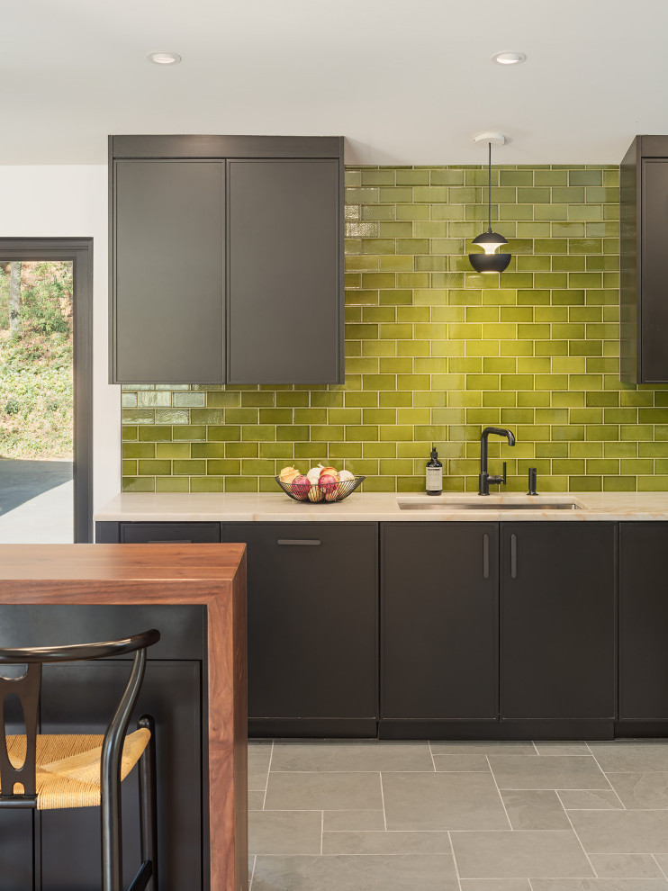 Inspiration for a midcentury kitchen in Philadelphia with recessed-panel cabinets, black cabinets, quartzite benchtops, green splashback, ceramic splashback, panelled appliances, slate floors, with island, green floor, beige benchtop and exposed beam.