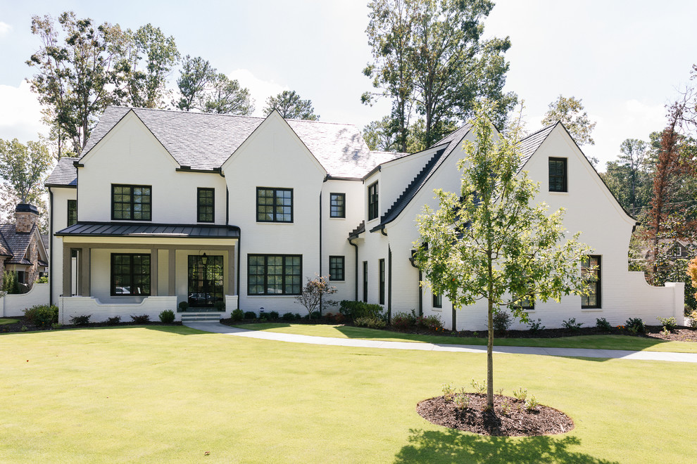This is an example of a mid-sized transitional three-storey brick white house exterior in Atlanta with a gable roof and a mixed roof.