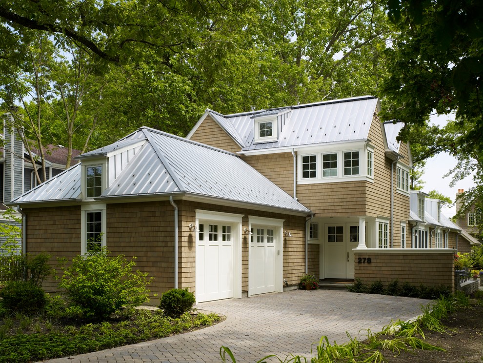 Photo of a mid-sized traditional three-storey beige exterior in Chicago with wood siding and a gable roof.