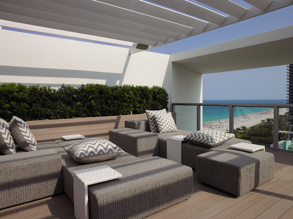 Inspiration for a modern deck in Miami with a pergola.