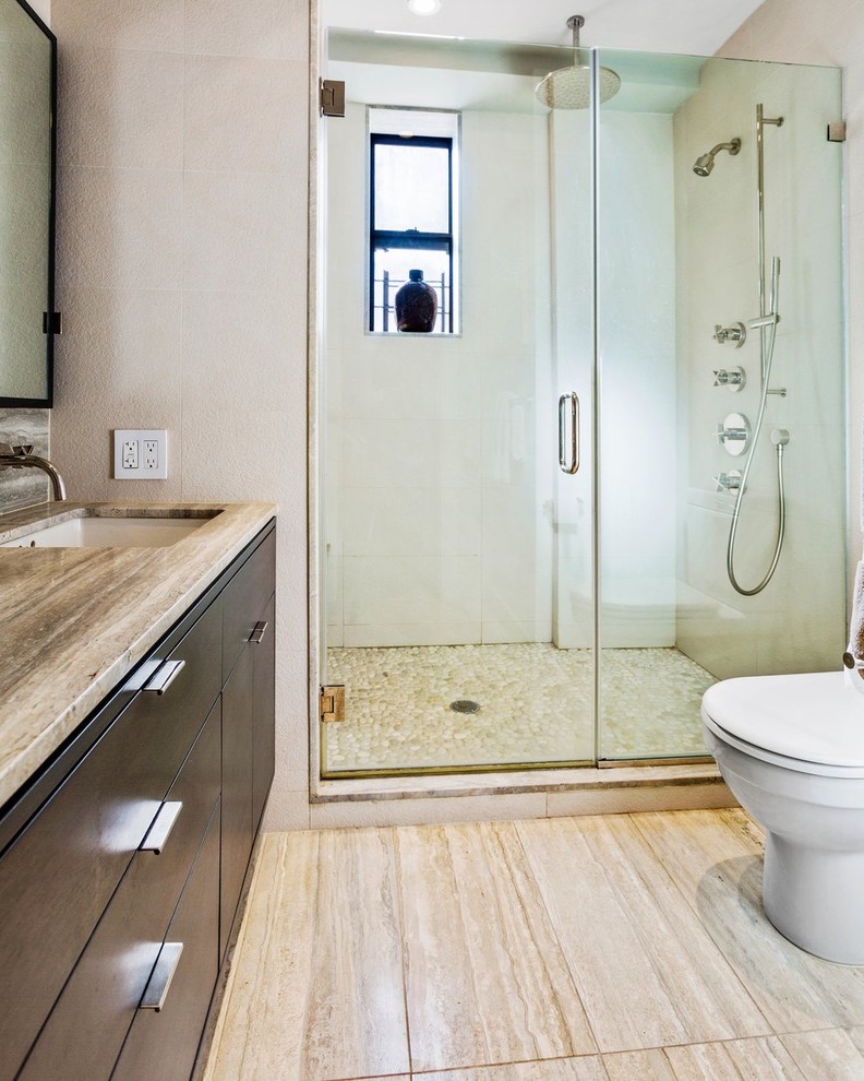 Design ideas for a large modern master bathroom in Other with furniture-like cabinets, medium wood cabinets, an alcove shower, a one-piece toilet, beige tile, stone tile, white walls, travertine floors, an undermount sink and terrazzo benchtops.