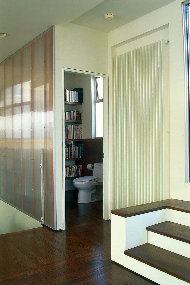 Photo of a modern hallway in San Francisco with beige walls and dark hardwood floors.