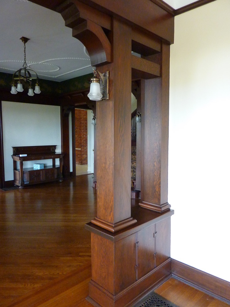 Inspiration for a large arts and crafts foyer in Portland with white walls and medium hardwood floors.