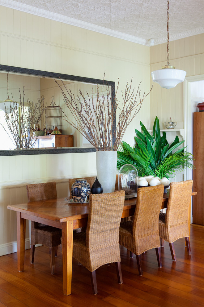 Inspiration for a transitional dining room in Brisbane with beige walls and medium hardwood floors.