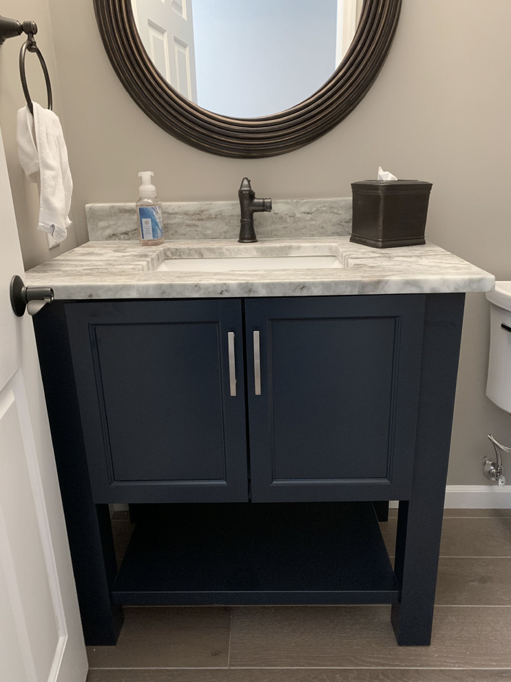 Design ideas for a mid-sized transitional 3/4 bathroom in Other with shaker cabinets, blue cabinets, a two-piece toilet, grey walls, granite benchtops and multi-coloured benchtops.