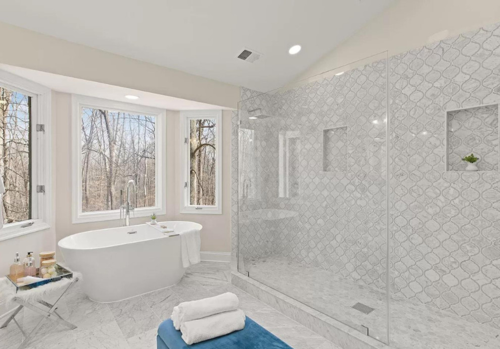 Large transitional master bathroom in DC Metro with white cabinets, a freestanding tub, a corner shower, gray tile, ceramic tile, beige walls, ceramic floors, a drop-in sink, marble benchtops, grey floor, an open shower, grey benchtops, a single vanity, shaker cabinets and a built-in vanity.