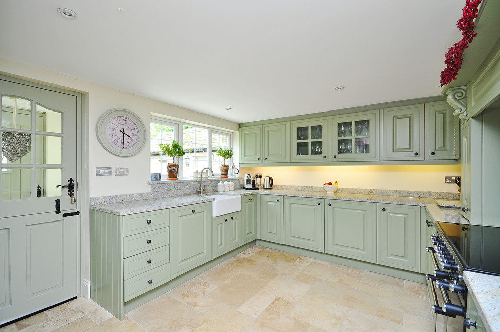 Photo of a country u-shaped kitchen in Other with a farmhouse sink, raised-panel cabinets, green cabinets, grey splashback, no island and granite benchtops.