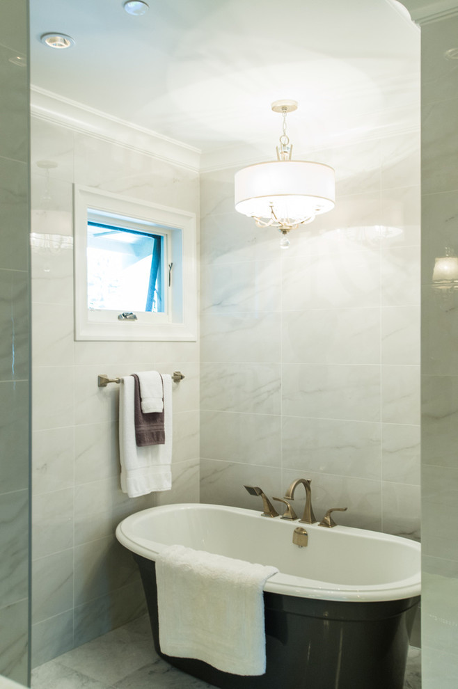 Design ideas for a large transitional master bathroom in Vancouver with an undermount sink, a freestanding tub, a double shower, a one-piece toilet, stone slab, white walls and slate floors.