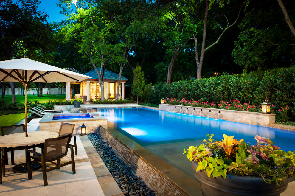 Inspiration for a large traditional rectangular pool in Dallas with a pool house.