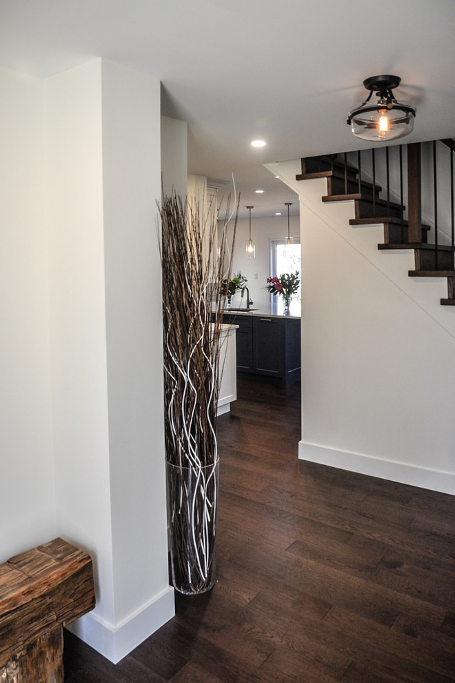 Inspiration for a mid-sized transitional dark wood floor and brown floor hallway remodel with white walls