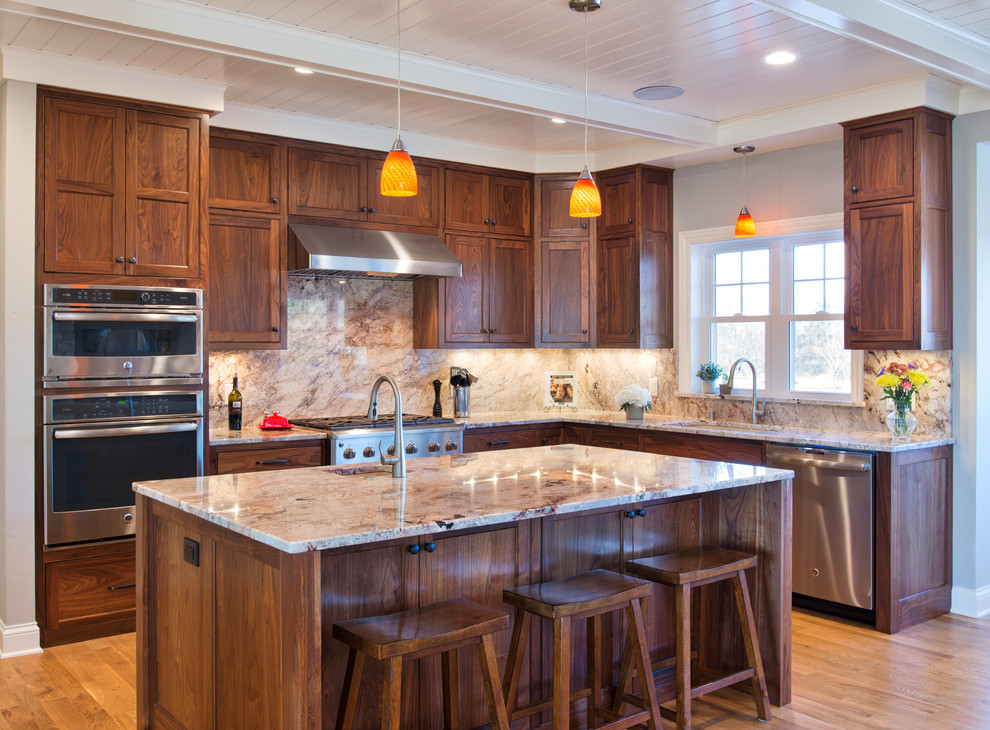Inspiration for a large transitional light wood floor and brown floor open concept kitchen remodel with an undermount sink, beaded inset cabinets, dark wood cabinets, granite countertops, stone slab backsplash, stainless steel appliances and an island