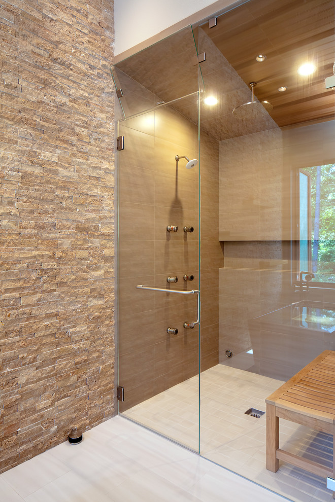 Design ideas for a large country master bathroom in Seattle with flat-panel cabinets, medium wood cabinets, a japanese tub, a curbless shower, a wall-mount toilet, brown tile, porcelain tile, grey walls, porcelain floors, an undermount sink, engineered quartz benchtops, beige floor, a hinged shower door and green benchtops.
