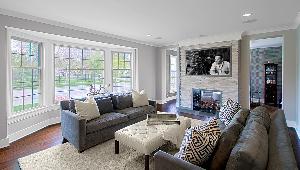 Mid-sized transitional open concept family room in Chicago with grey walls, dark hardwood floors, a two-sided fireplace, a stone fireplace surround and a wall-mounted tv.