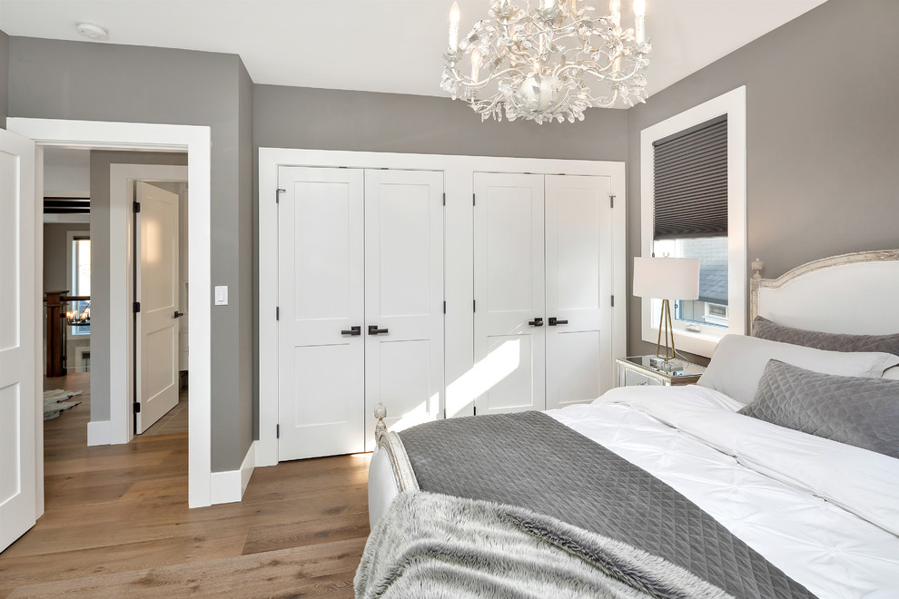 Inspiration for a transitional medium tone wood floor and brown floor bedroom remodel with gray walls