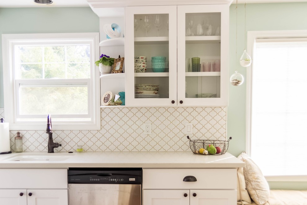 Design ideas for a small transitional galley eat-in kitchen in Seattle with an undermount sink, shaker cabinets, white cabinets, white splashback, ceramic splashback, stainless steel appliances, light hardwood floors and no island.