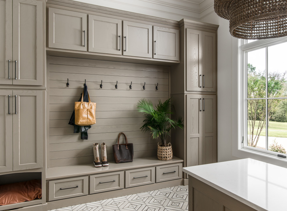 Inspiration for a large transitional l-shaped dedicated laundry room in Nashville with an undermount sink, shaker cabinets, beige cabinets, quartz benchtops, white walls, porcelain floors, a side-by-side washer and dryer and white benchtop.