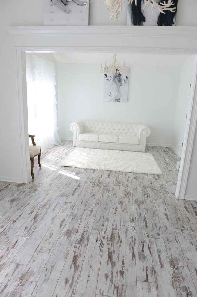 Photo of a large transitional living room in Cleveland with white walls and laminate floors.