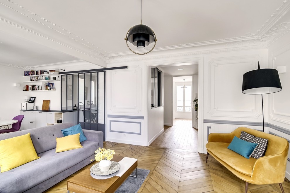 Design ideas for a large scandinavian formal open concept living room in Paris with white walls and light hardwood floors.