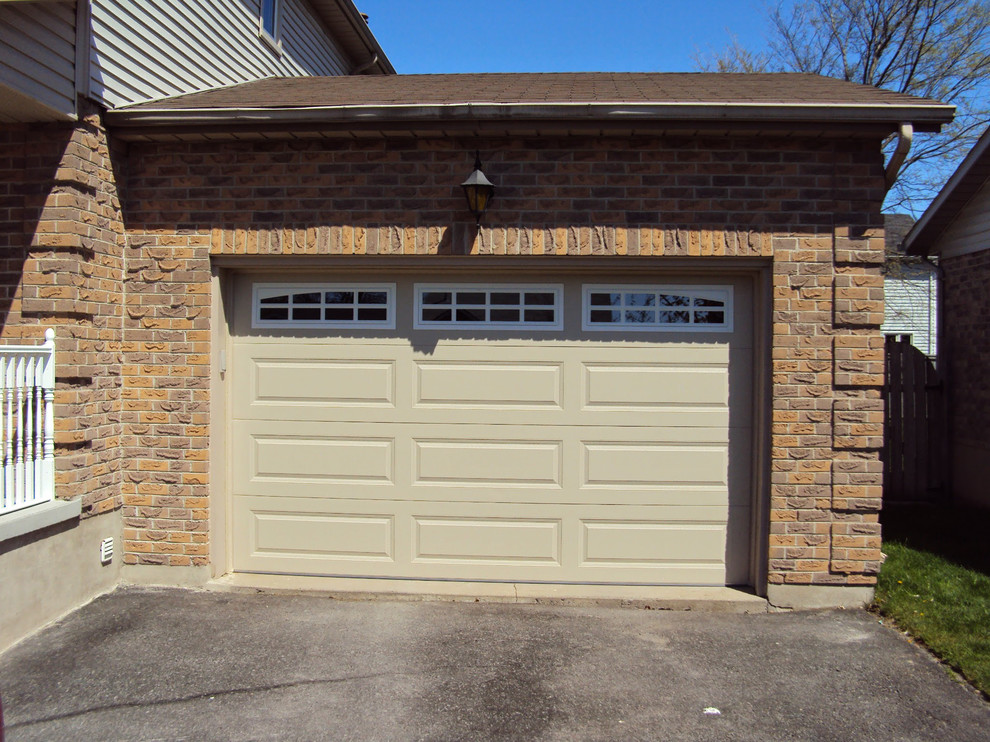 This is an example of a large traditional attached two-car garage in Other.