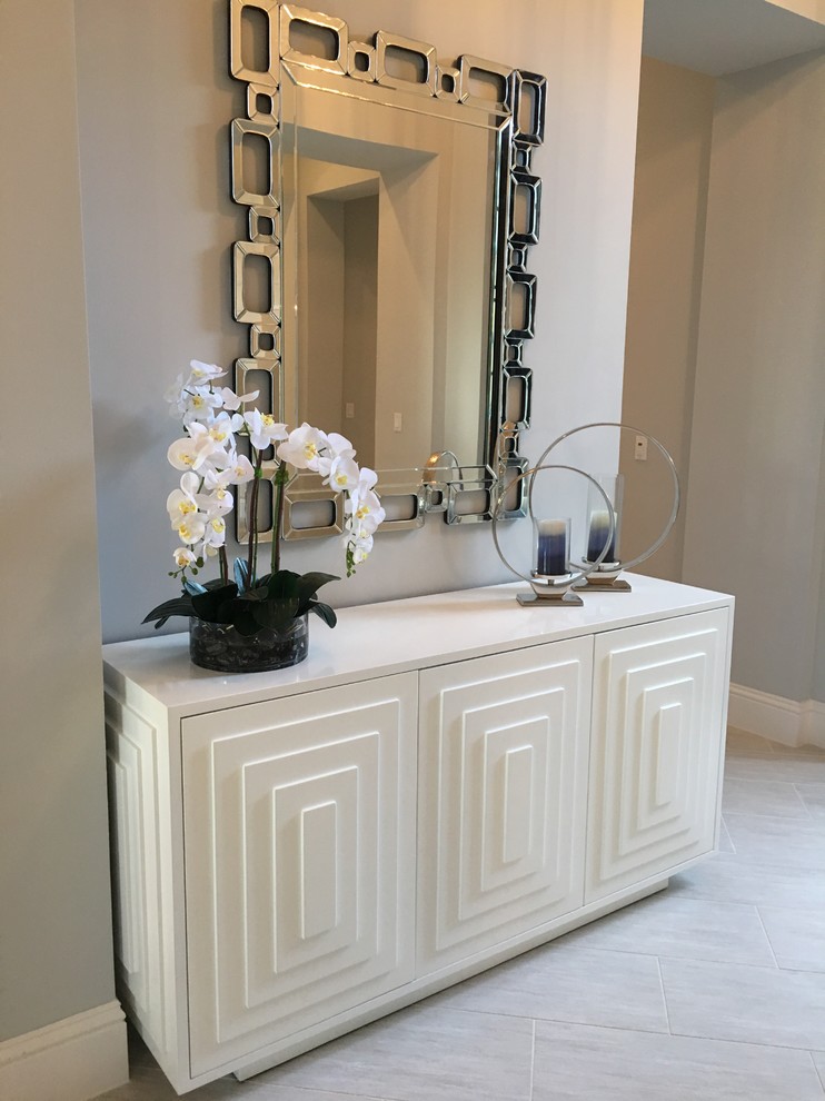 Inspiration for a transitional porcelain tile entryway remodel in Miami with gray walls