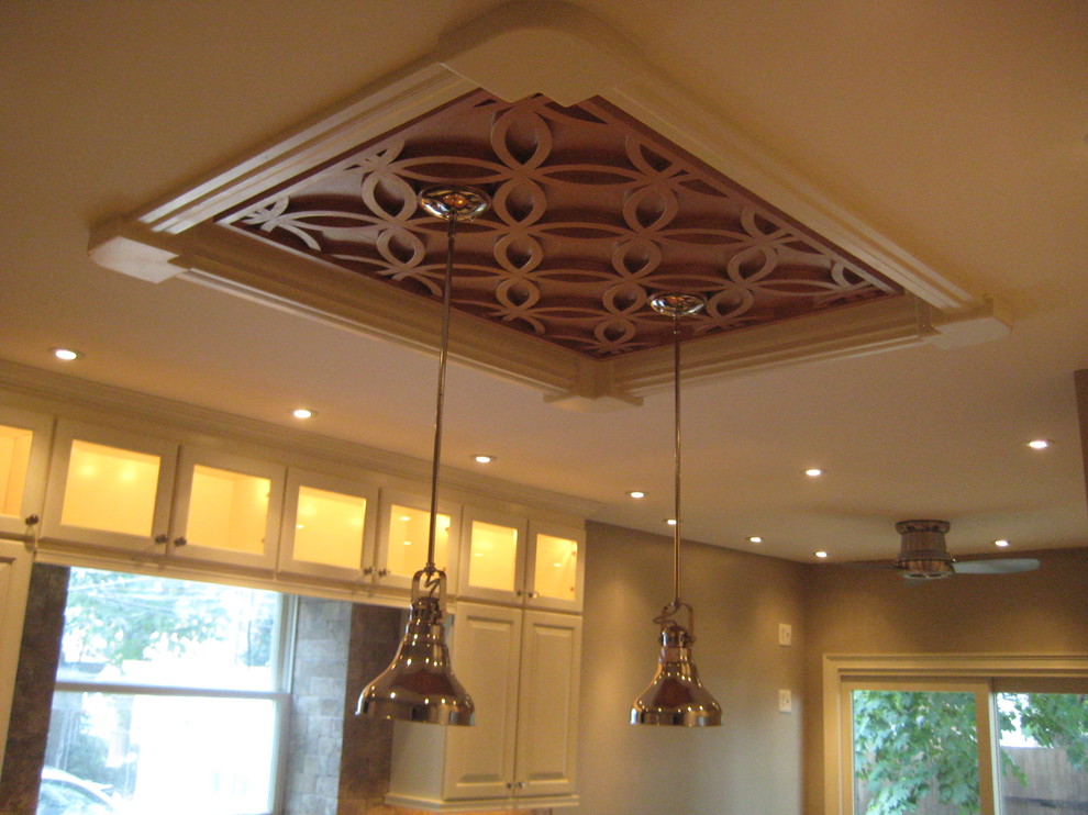 Inspiration for a transitional l-shaped eat-in kitchen remodel in Philadelphia with a single-bowl sink, raised-panel cabinets, white cabinets, granite countertops, brown backsplash, stone tile backsplash and stainless steel appliances