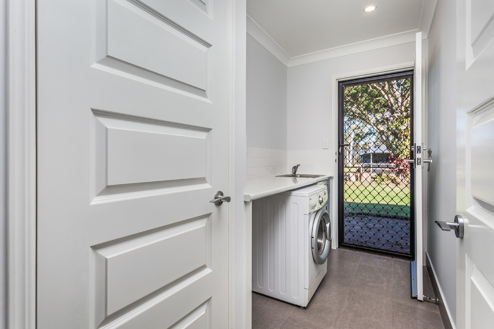 Transitional laundry room in Brisbane.