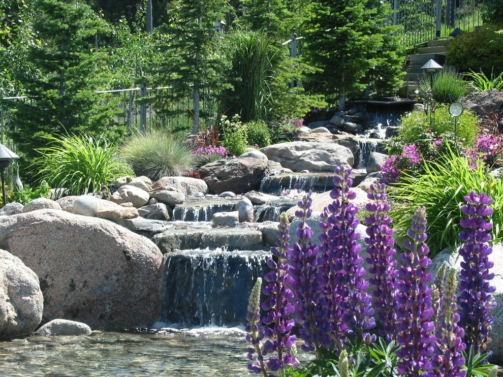 Photo of a traditional garden in Seattle with a water feature.