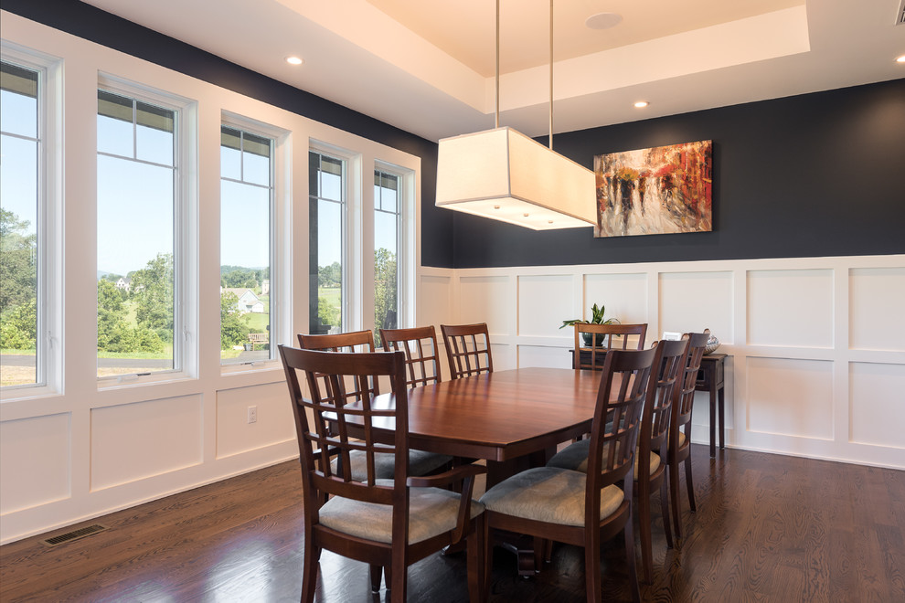 Mid-sized transitional separate dining room in Other with black walls, dark hardwood floors and brown floor.