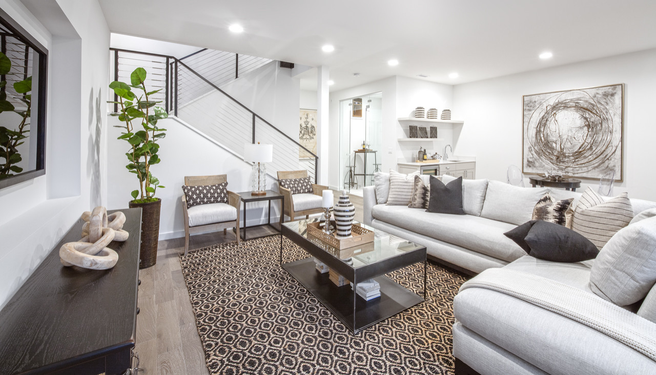 The lower level is all about having fun.  The large room is great for lounge seating and a game table.  The cable guardrail carried down from the main floor keeps the room feeling open.  The same hard