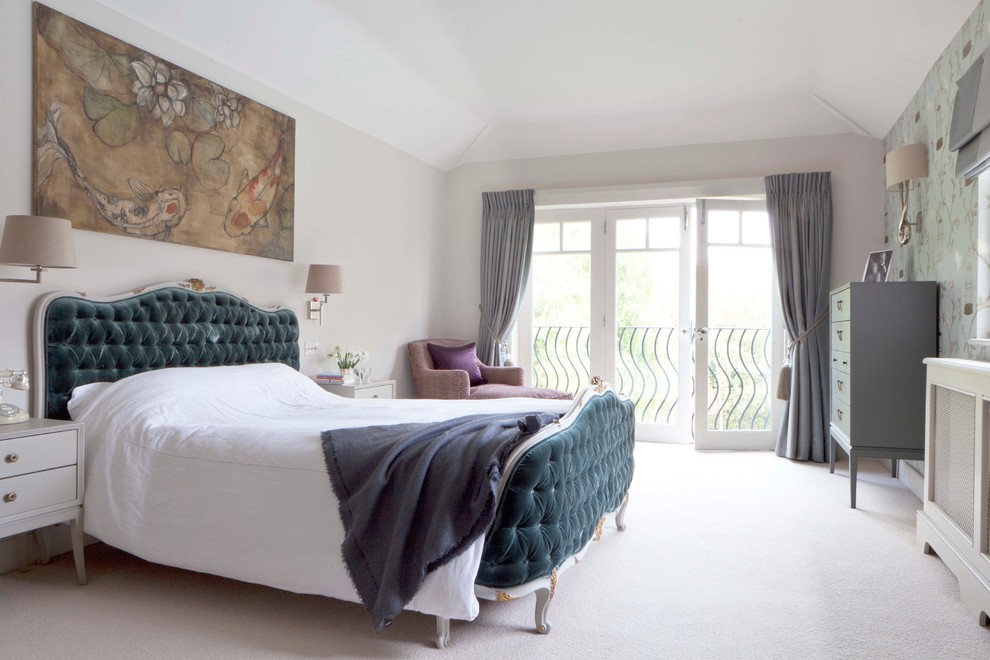Photo of a traditional master bedroom in London with beige walls and carpet.