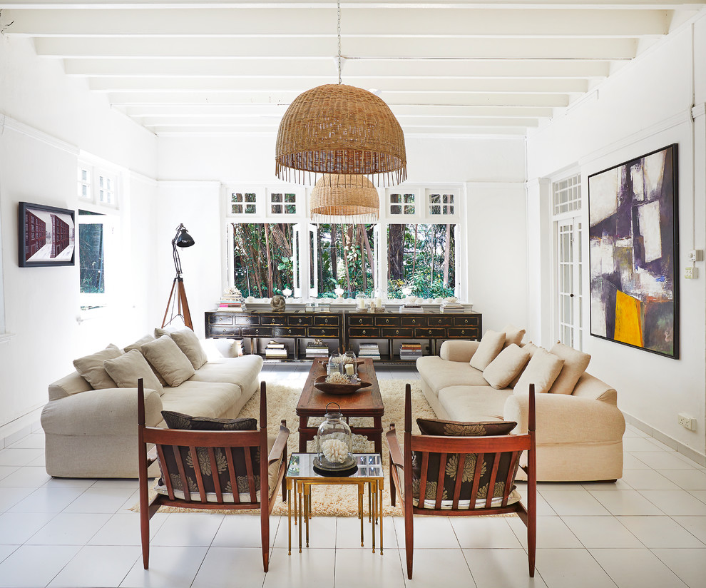 Inspiration for a tropical formal enclosed living room with white walls, no fireplace, no tv and white floor.