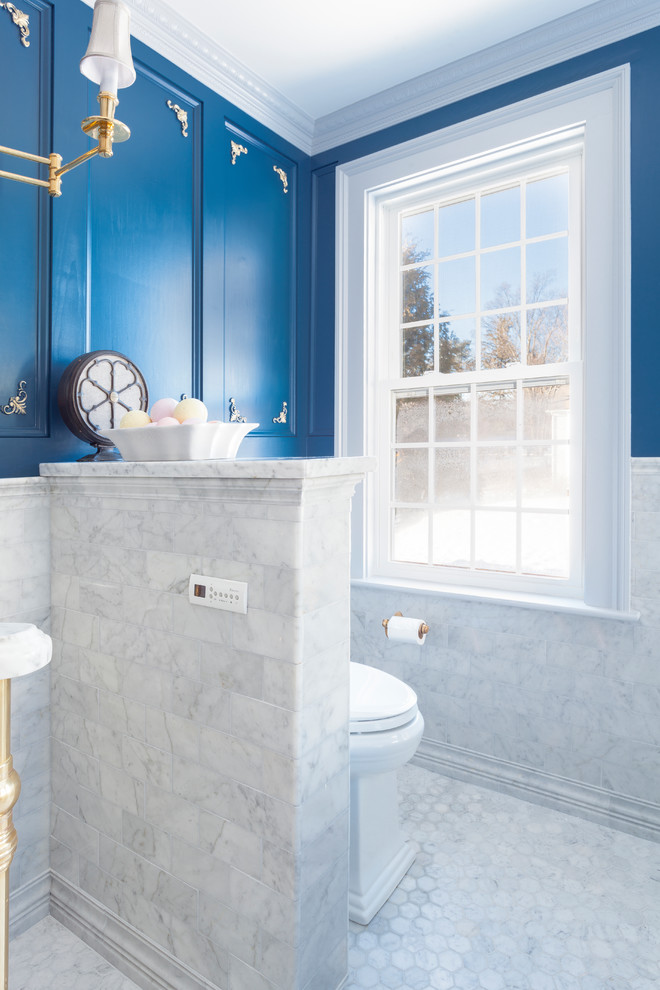 Mid-sized traditional master bathroom in Boston with a freestanding tub, an alcove shower, a one-piece toilet, gray tile, marble, blue walls, marble floors, an undermount sink, marble benchtops, grey floor, a hinged shower door and grey benchtops.