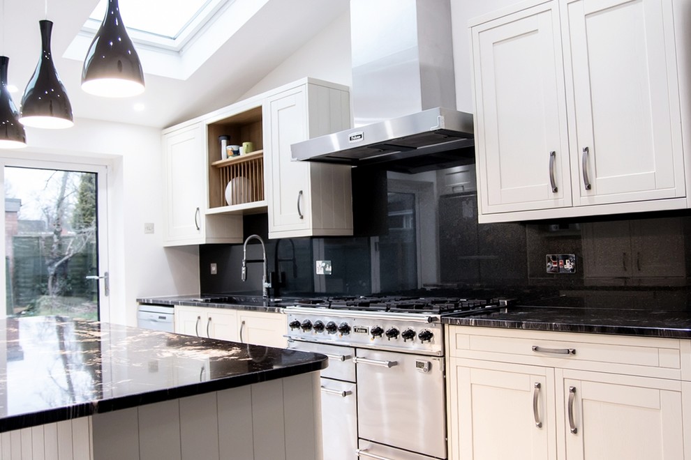 This is an example of a modern kitchen in Hertfordshire with black splashback and glass sheet splashback.