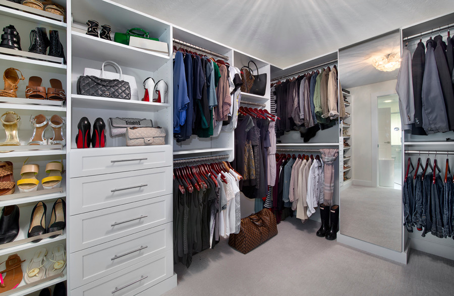 Large contemporary gender-neutral walk-in wardrobe in Miami with shaker cabinets, white cabinets, carpet and beige floor.