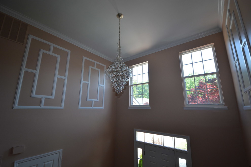 Foyer - large transitional dark wood floor foyer idea in Baltimore with orange walls and a white front door