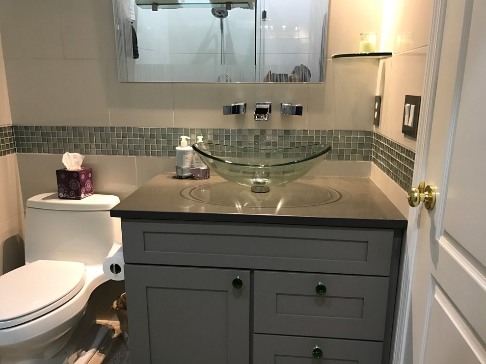 Small contemporary master bathroom in Tampa with shaker cabinets, grey cabinets, a freestanding tub, a corner shower, a two-piece toilet, gray tile, white tile, ceramic tile, white walls, porcelain floors, an undermount sink, engineered quartz benchtops and grey benchtops.