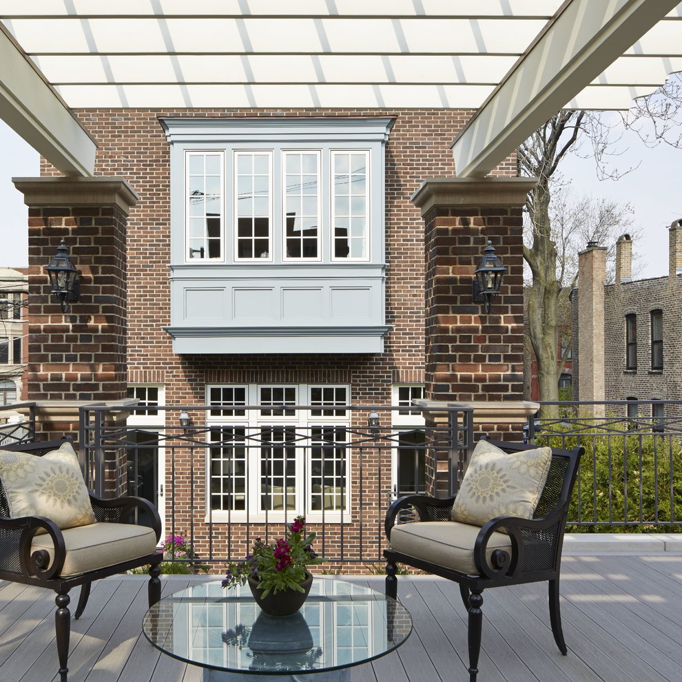 Inspiration for a large traditional rooftop deck in Chicago with an outdoor kitchen and a pergola.