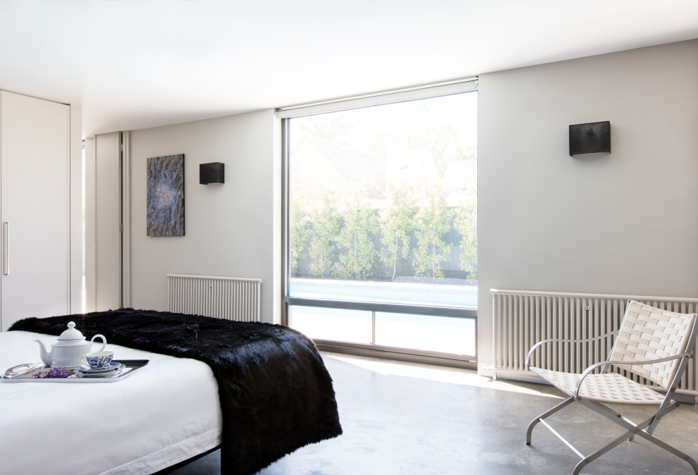 Inspiration for a mid-sized contemporary master bedroom in Melbourne with grey walls, concrete floors and grey floor.