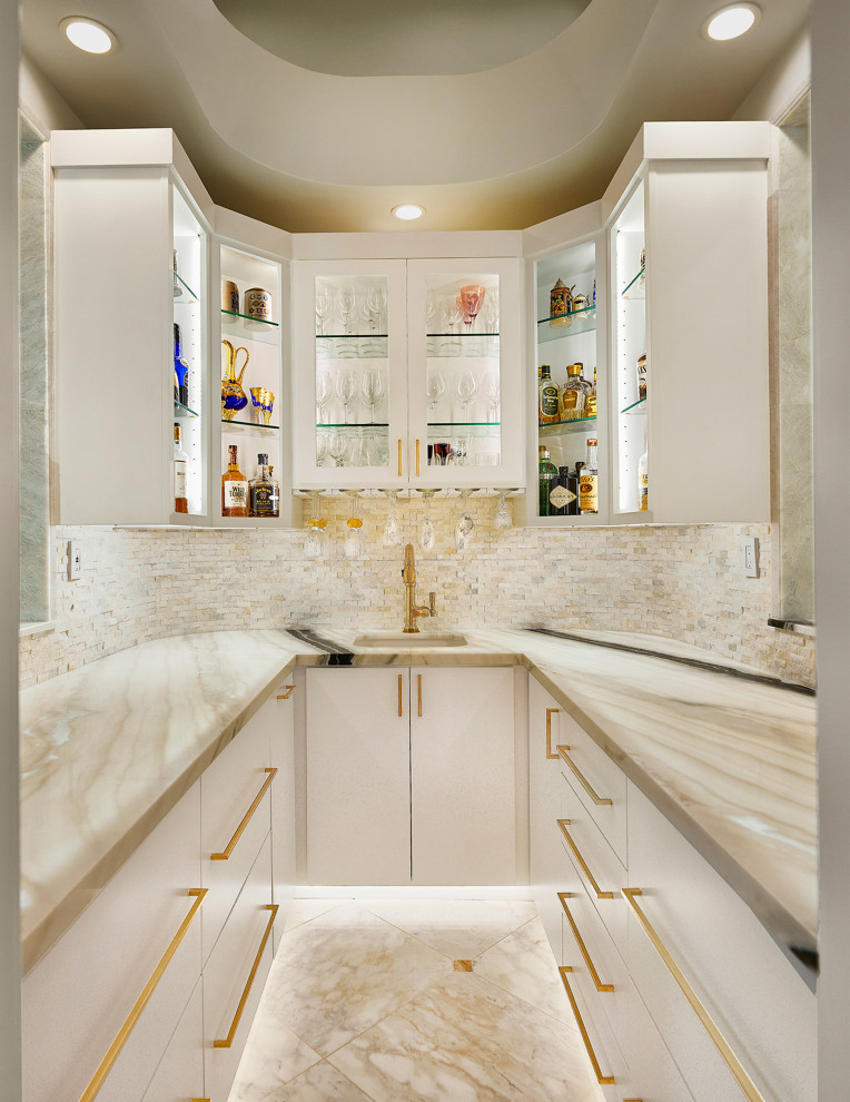 Example of a small trendy u-shaped marble floor and white floor wet bar design in Dallas with an undermount sink, flat-panel cabinets, white cabinets, quartz countertops, white backsplash, matchstick tile backsplash and white countertops