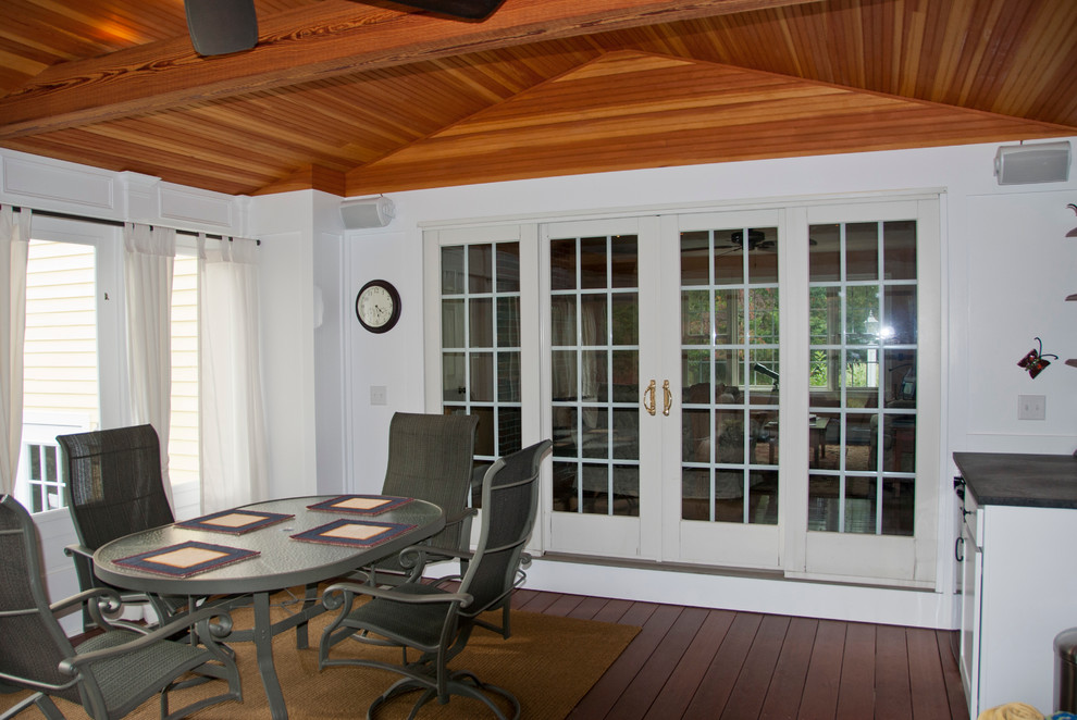 Design ideas for a mid-sized traditional sunroom in Manchester with medium hardwood floors, no fireplace and a standard ceiling.