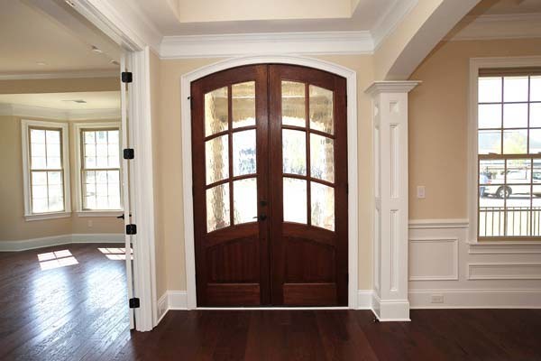 Large elegant dark wood floor entryway photo in Charlotte with beige walls and a dark wood front door