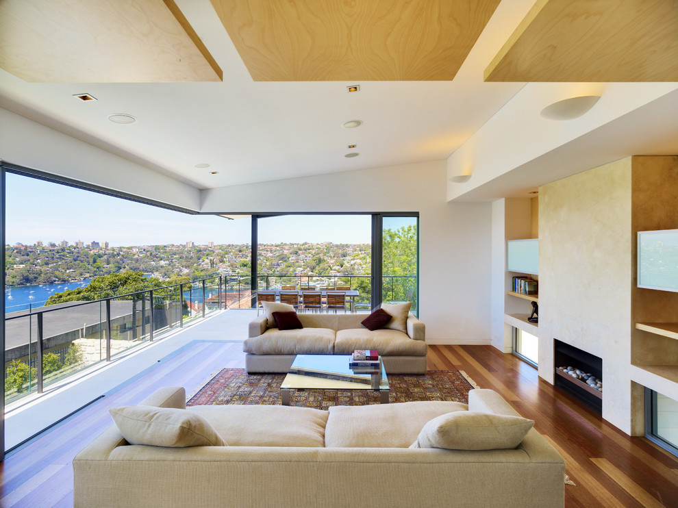 Photo of a large contemporary living room in Sydney with white walls, medium hardwood floors and a ribbon fireplace.