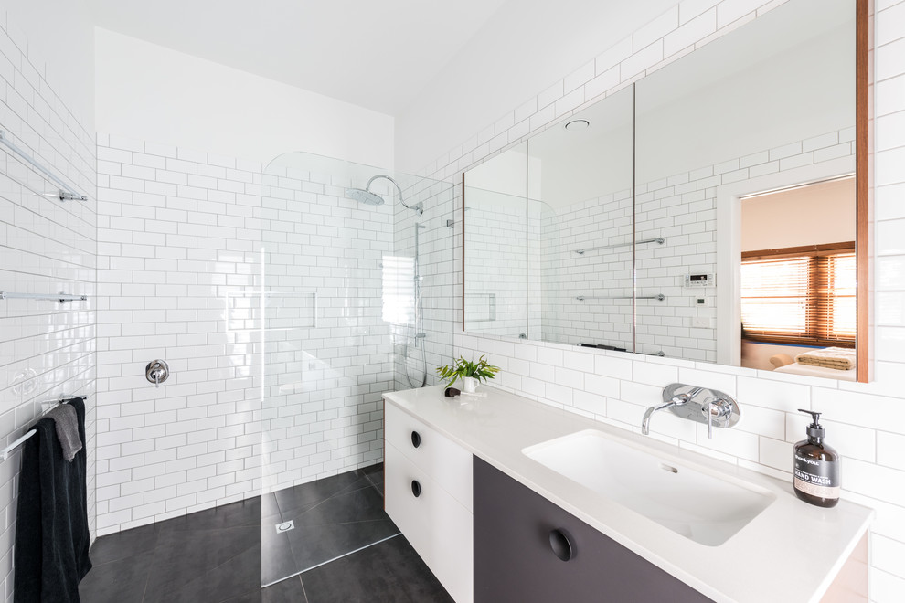 Photo of a large eclectic galley bathroom in Melbourne with an undermount sink, flat-panel cabinets, quartz benchtops, mosaic tile splashback, stainless steel appliances, light hardwood floors and with island.