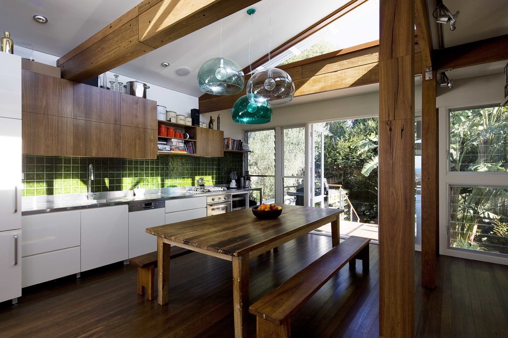 Inspiration for a contemporary single-wall eat-in kitchen in Sydney with flat-panel cabinets, white cabinets, green splashback and panelled appliances.