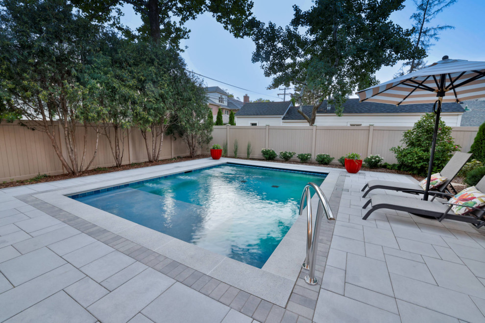 Example of a small classic backyard stone and rectangular pool house design in Chicago