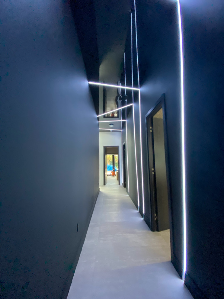 Foto di un piccolo ingresso o corridoio moderno con pareti nere, pavimento in cemento, pavimento grigio, soffitto ribassato e carta da parati