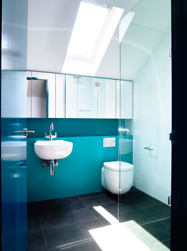 Design ideas for a contemporary kids bathroom in Melbourne with a wall-mount sink, flat-panel cabinets, laminate benchtops, an open shower, a wall-mount toilet, ceramic tile and white walls.