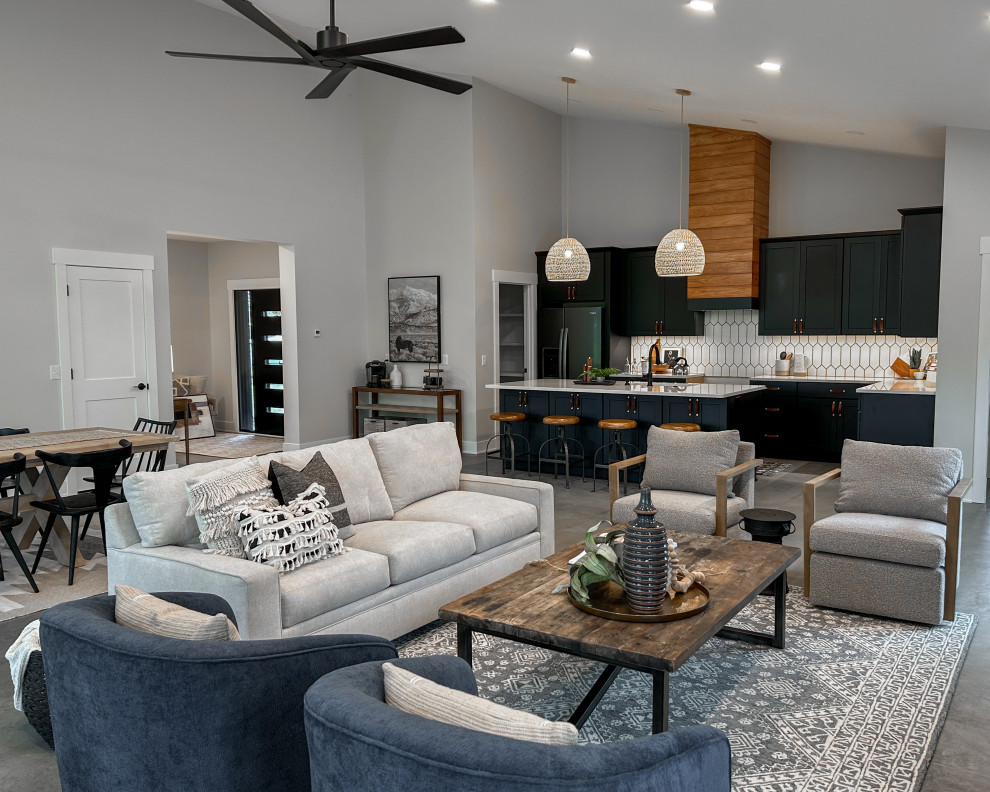 Photo of a mid-sized country open concept living room in Columbus with white walls, concrete floors, no fireplace, no tv, grey floor and vaulted.
