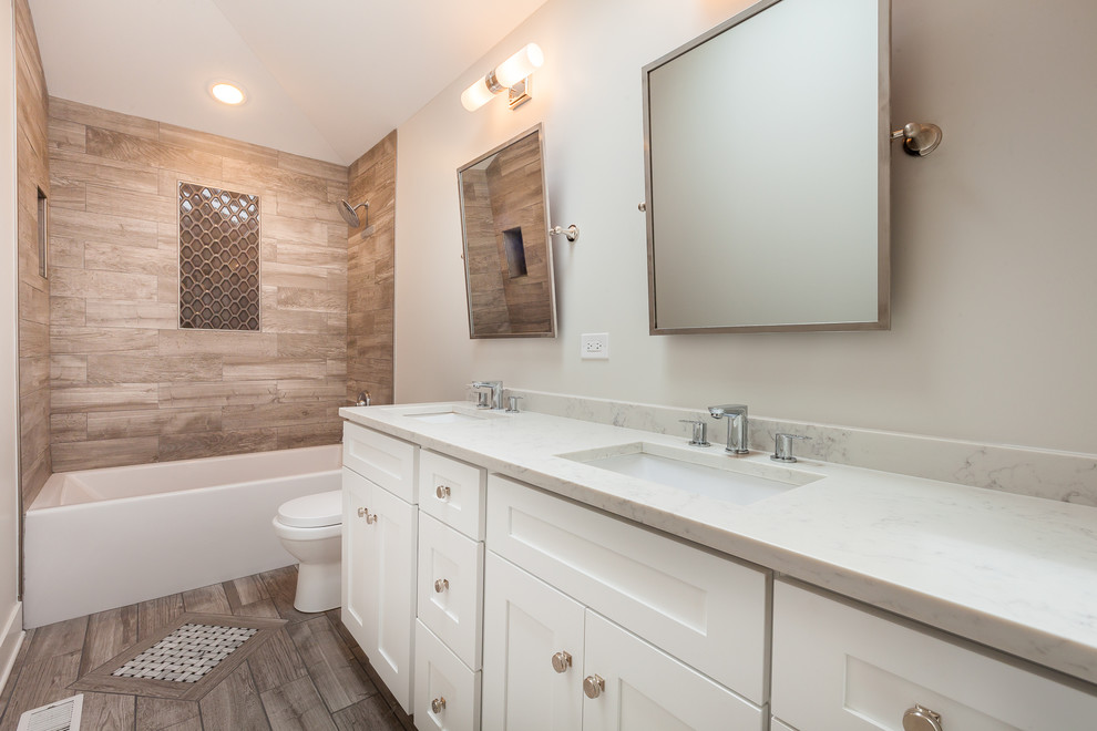 Inspiration for a mid-sized midcentury kids bathroom in Chicago with shaker cabinets, white cabinets, an alcove tub, a shower/bathtub combo, a one-piece toilet, brown tile, ceramic tile, grey walls, ceramic floors and an undermount sink.