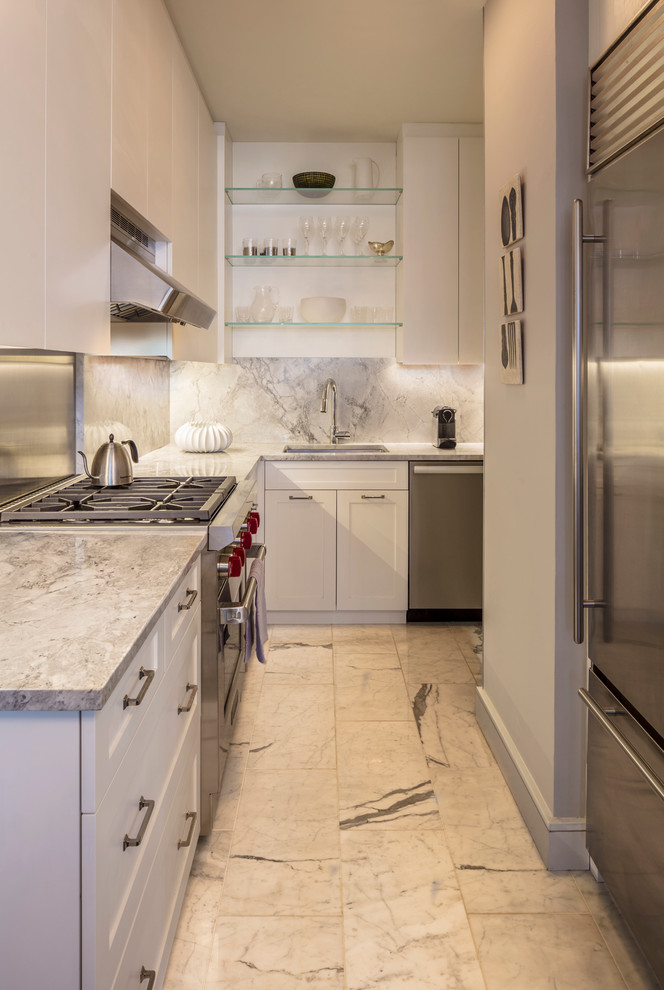 Photo of a mid-sized modern l-shaped separate kitchen in New York with flat-panel cabinets, white cabinets, marble benchtops, white splashback, stainless steel appliances, marble floors, no island, an undermount sink and stone slab splashback.